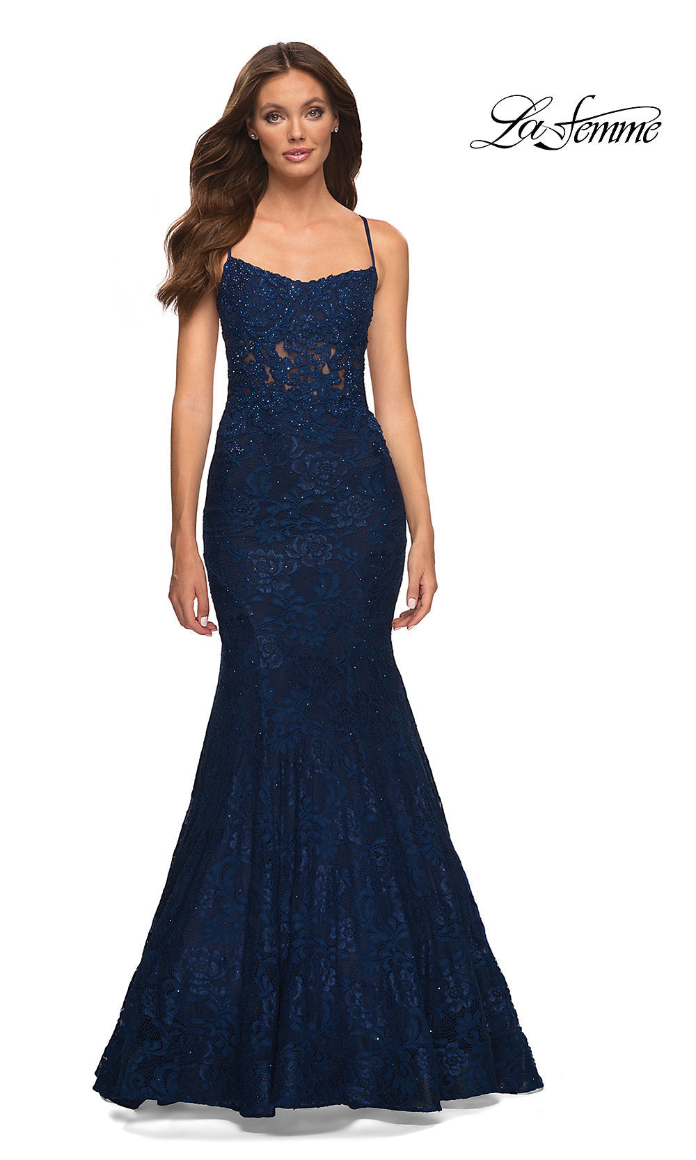 A woman models the Open-Back Long Lace Mermaid Prom Dress by La Femme in navy, featuring spaghetti straps, against a white background with the La Femme logo in the top right corner.